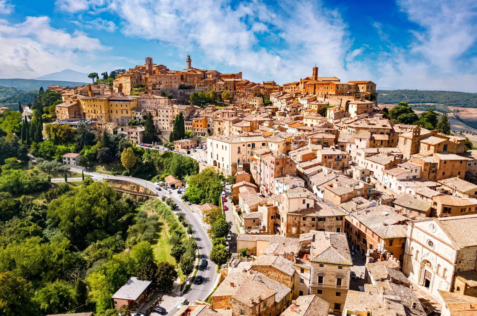 Aerial view of a Tuscan hilltop town of terracotta rooftops and towers
