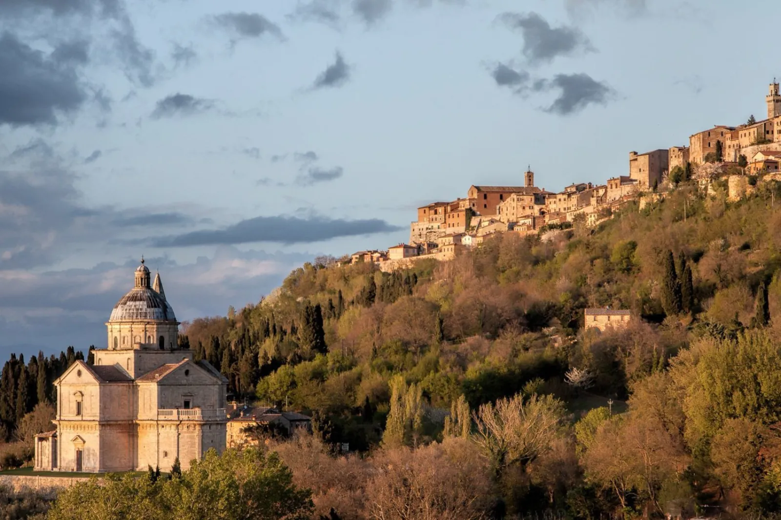 Montepulciano on its ridge at golden hour, with the San Biagio church below